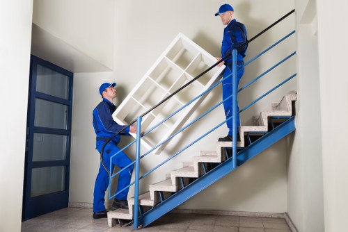 Local movers handling boxes in a residential Abbeywood street