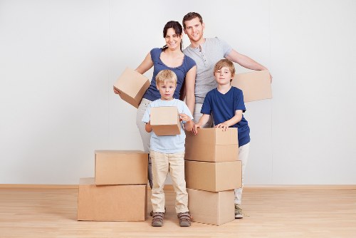 Movers carrying furniture through an Abbeywood residential property