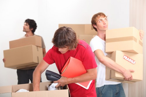 Piano movers using protective equipment during a local house move